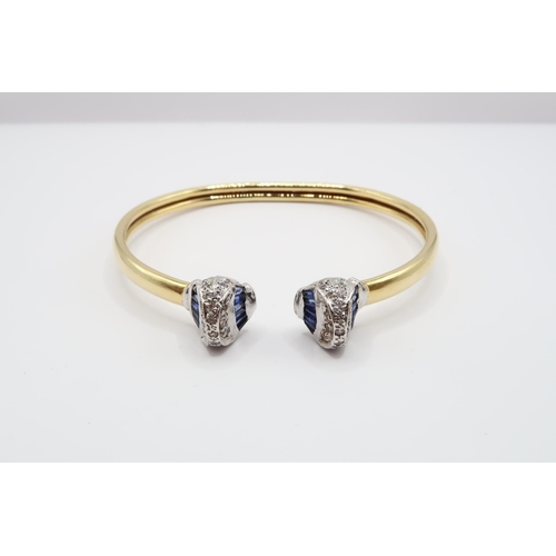 1 - An 18ct Gold Sapphire & Diamond Torque, ends individually set with tapered baguette sapphires with r... 