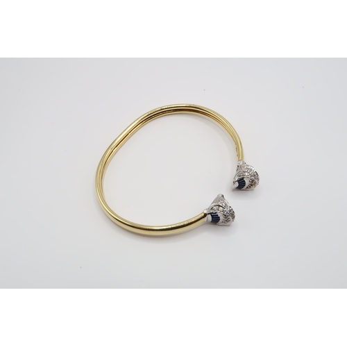 1 - An 18ct Gold Sapphire & Diamond Torque, ends individually set with tapered baguette sapphires with r... 