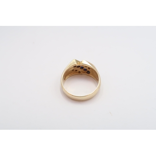 14 - A sapphire and diamond three row dress ring. Stamped 14K. Size S 1/2. Weight 8.47 grams