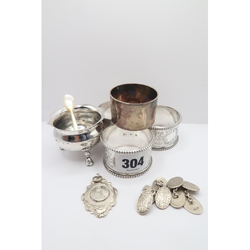304 - A Small Group of silver items to include Two pairs of Cufflinks, Three Napkin Rings and a Salt Cella... 