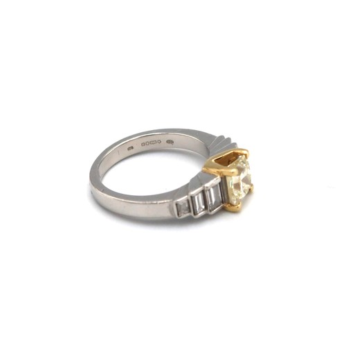 4 - An 18ct gold and platinum ring designed as a fancy light yellow princess cut diamond with three grad... 