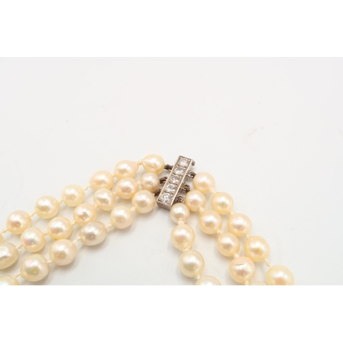 20 - A 18ct & Diamond Three Strand Cultured Pearl Necklace, Clasp is of a bar form with Five Claw Set... 