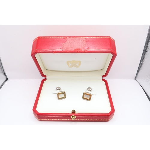 21 - A Pair of Cartier Santos Steel & 18ct Gold Cufflinks. Numbered BM5929, With original box and cer... 