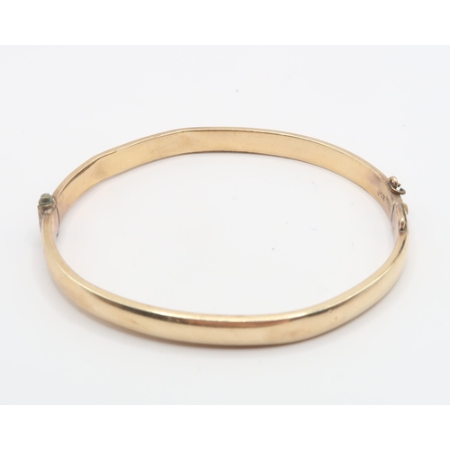 103 - A 9ct Metal Core Bangle. Weight: 6.56g