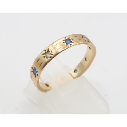 106 - A 9ct Paste Stone Set Band, Star set blue and white stones.Weight: 2.3g Size: N