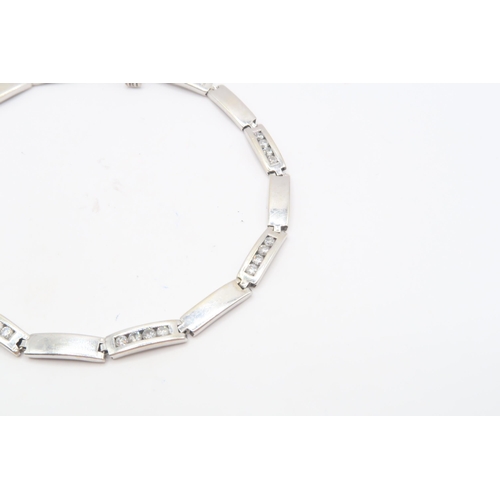 111 - A 9ct Diamond Bar Link Bracelet, Composed of alternating polished and diamond-set rectangular links.... 
