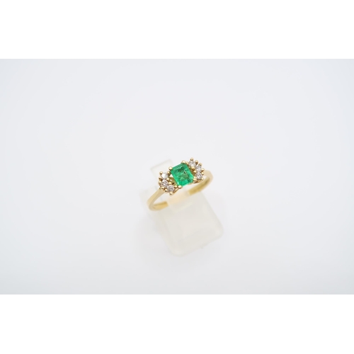 19 - An 18ct yellow gold (tested) emerald and diamond ring, emerald has natural inclusions, diamonds brig... 