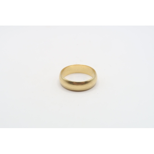 65 - A 6.5mm band ring. Size W. Weight 8.54 grams. Tests gold 18ct