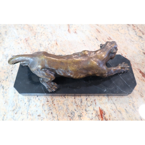 460 - A bronze statue of a crouching Jaguar on a marble base, good condition, 43cm wide x 16cm high incl b... 