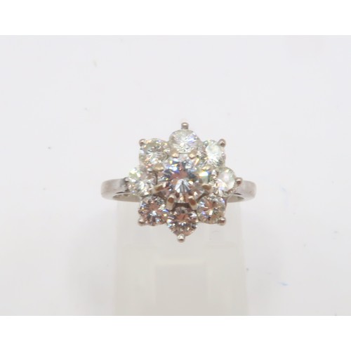 3 - An 18ct gold diamond daisy cluster ring. Estimated total diamond weight 1.30cts. Estimated G/H colou... 