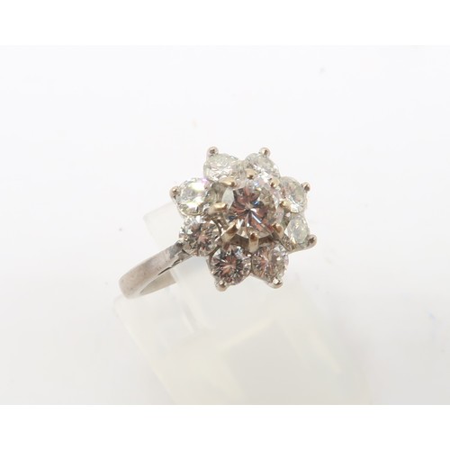 3 - An 18ct gold diamond daisy cluster ring. Estimated total diamond weight 1.30cts. Estimated G/H colou... 