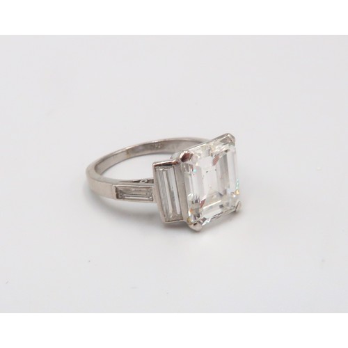 2 - A Deco Style Diamond Dress Ring - The central emerald cut diamond with a vertical baguette to each s... 
