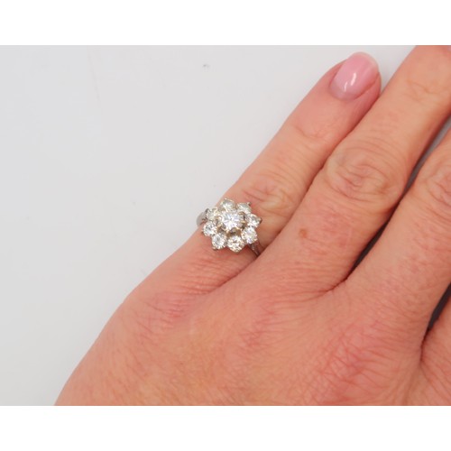 3 - An 18ct gold diamond daisy cluster ring. Estimated total diamond weight 1.30cts. Estimated G/H colou... 