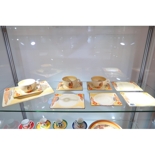 465 - A Clarice Cliff Biaritz - Eight saucers, three cups, a sandwich plate - some crazing