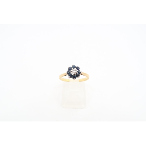 175 - A sapphire and diamond floral cluster ring. Stamped 18ct. Size N 1/2. Weight 2.57 grams