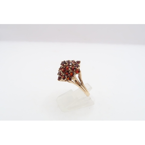 45 - A 9ct gold garnet bombe style cluster ring. Size O. Weight 5.65 grams