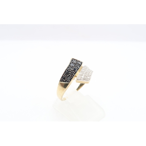 48 - A 9ct gold black diamond and diamond crossover panel ring. Size P. Weight 3.08 grams