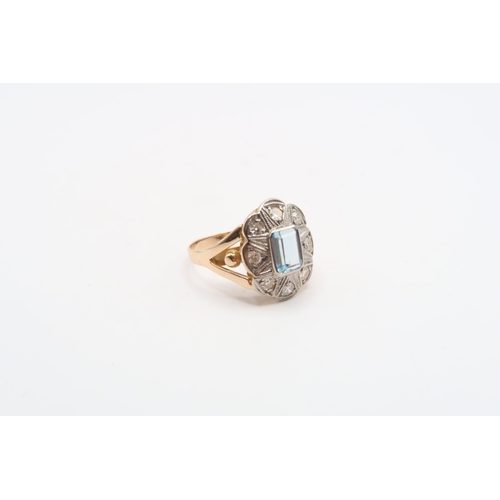 54 - An aquamarine and diamond cluster ring. Tests gold 18ct. Size K 1/2. Weight 3.28 grams&nbsp;