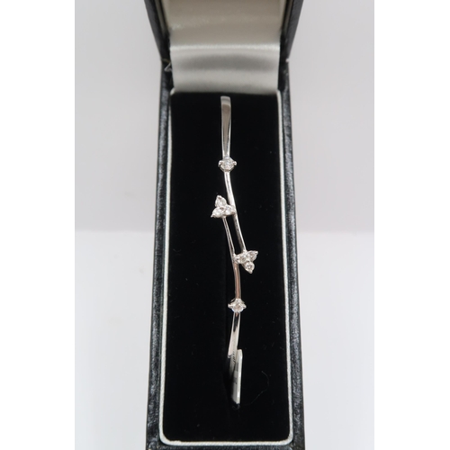 55 - A crossover hinged bangle with trefoil diamond detail. Stamped 18K 750 D 0.25. Weight 7.47 grams