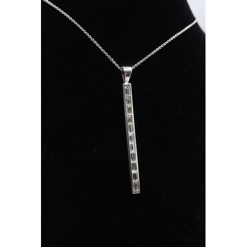 57 - An 18ct gold baguette diamond line pendant. Length of pendant 40mm. Weight 3.62 grams