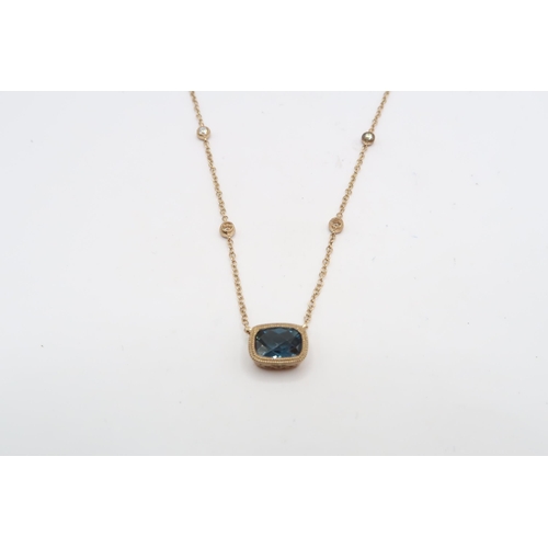 58 - A 9ct gold blue topaz and diamond pendant. Weight 1.98 grams