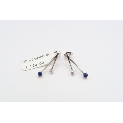 59 - A pair of 18ct sapphire and diamond two stone earrings. Length 21mm. Weight 2.85 grams