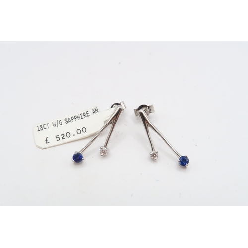 59 - A pair of 18ct sapphire and diamond two stone earrings. Length 21mm. Weight 2.85 grams