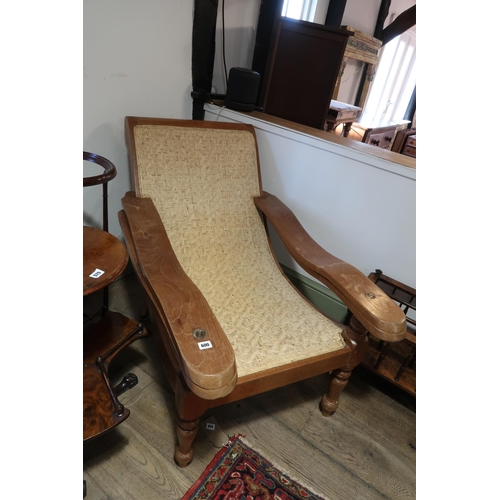 600 - An early 20th century cherry wood British Colonial Plantar's chair with woven cane curved seat, some... 