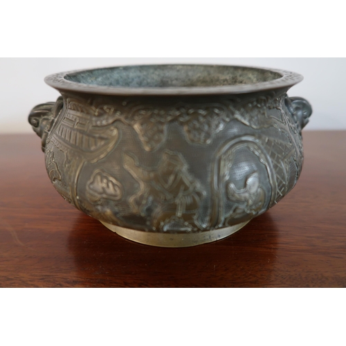  A 19th Century heavy bronze Chinese censer. featuring a globular form with a flared floral engraved ... 