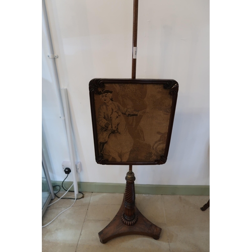  A Regency rosewood pole screen on a turned and reeded stem and platform base