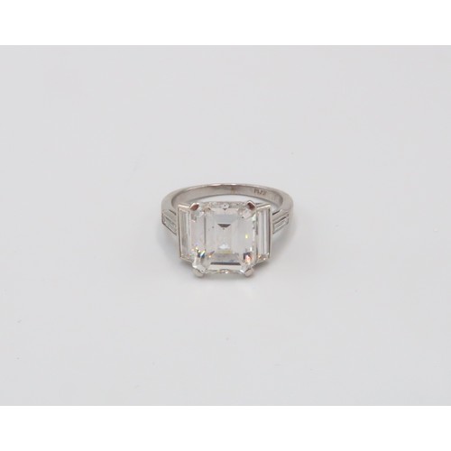 19 - A Deco Style Diamond Dress Ring - The central emerald cut diamond with a vertical baguette to each s... 
