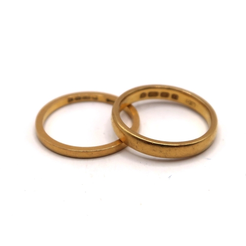 A 3mm 22ct gold band ring size N.Together with a 1.7mm 22ct band ring size M 1/2. Weight 6.54 grams