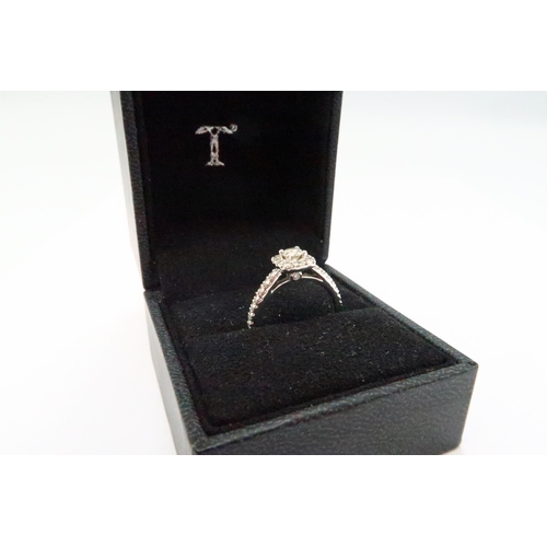 5 - An 18ct gold diamond halo ring. With Tolkowsky report stating the central diamond to be 0.23ct. Colo... 