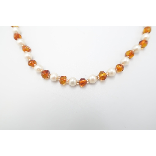 10 - A 9ct Amber & Pearl Necklace with oval floral clasp.&nbsp;Weight: 27g Length: 65cm&nbsp;... 