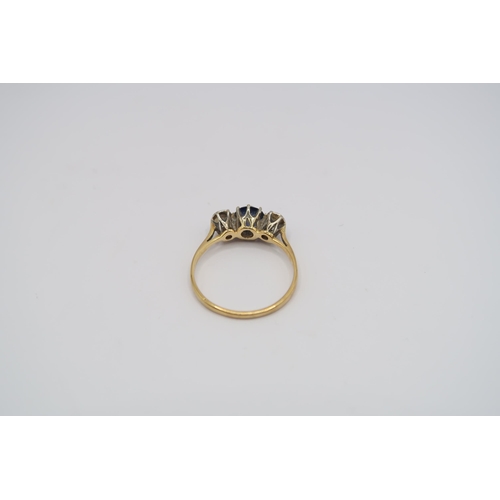 &nbsp;A sapphire and diamond three stone ring. Stamped 18ct. Size M. Weight 1.79 grams