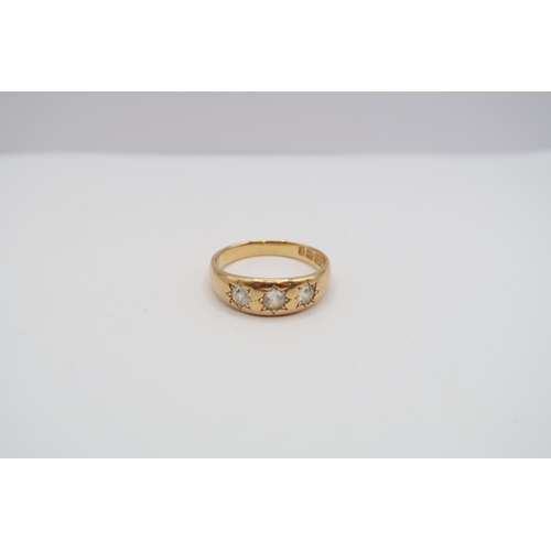 An 18ct gold old cut diamond three stone band ring. Estimated 0.50ct. Size S. Weight 5.45 grams