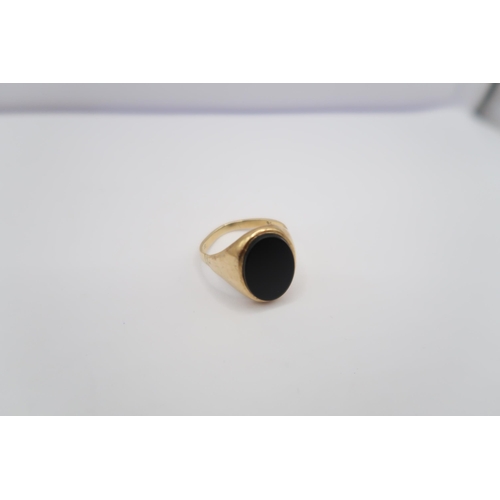  An oval onyx signet ring, stamped 9ct. Size V 1/2. Weight 4.60 grams