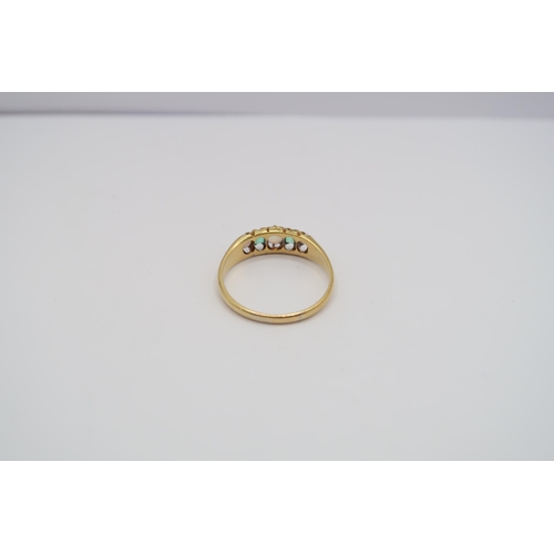  An emerald and opal ring. Tests 18ct. Size R. Weight 2.88 grams&nbsp;