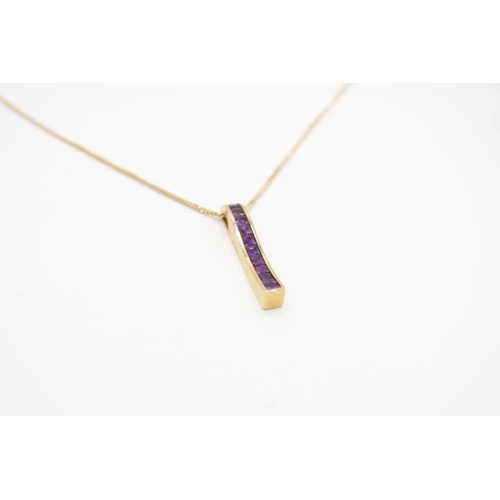 54 - An 18ct Amethyst Pendant & Chain, Featuring a channel set wave design.&nbsp;Weight: 7.54g Length... 