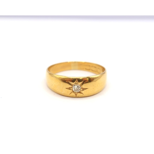 69 - A single stone diamond band ring. Tests 18ct. Size P. Weight 4.04 grams