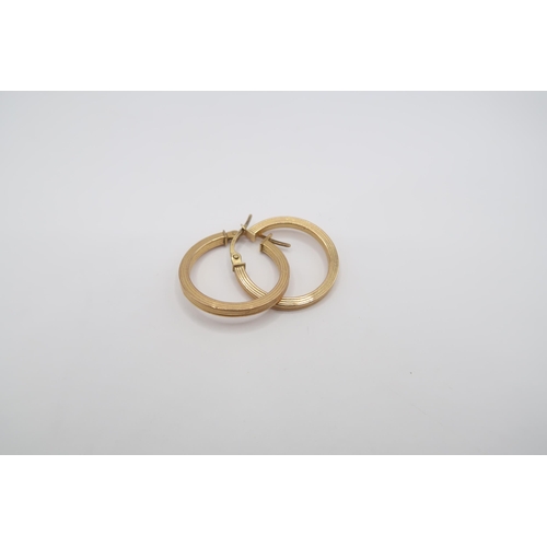 87 - A pair of grooved hoop earrings. Stamped 375. Weight 1.19 grams