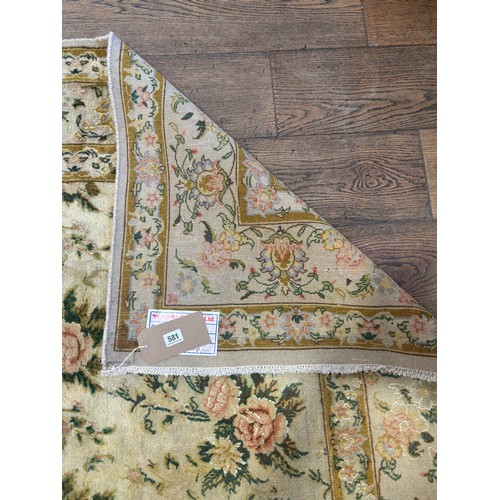 581 - A hand knotted woollen Tabriz rug - 2.55m x 1.90m
