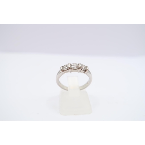 136 - A platinum brilliant cut diamond three stone ring. Estimated 0.80ct. Estimated G/H VS. Size K 1/2. W... 