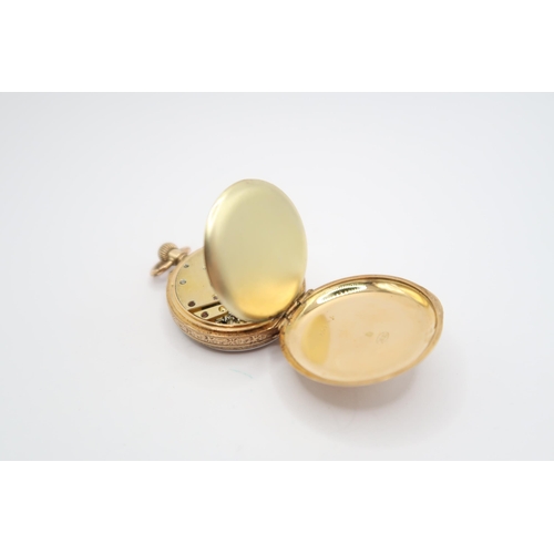 261 - An 18ct Open Faced Pocket Watch, Featuring a Scroll Worked case with gold coloured dial and black ro... 