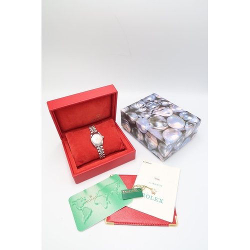 A 2001 Stainless Steel Ladies Rolex Oyster Perpetual, Reference 76080, 32mm. Featuring a Smooth Bezel, Pink Lumed Dial with Arabic numerals and baton hour indices. Box & Papers