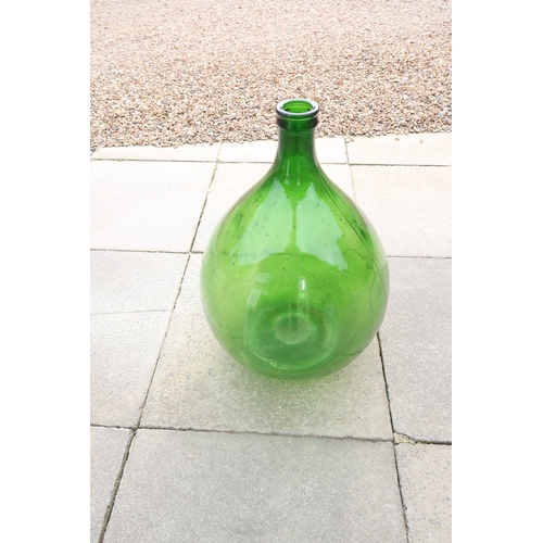 625 - A green glass bottle - approx 70cm tall