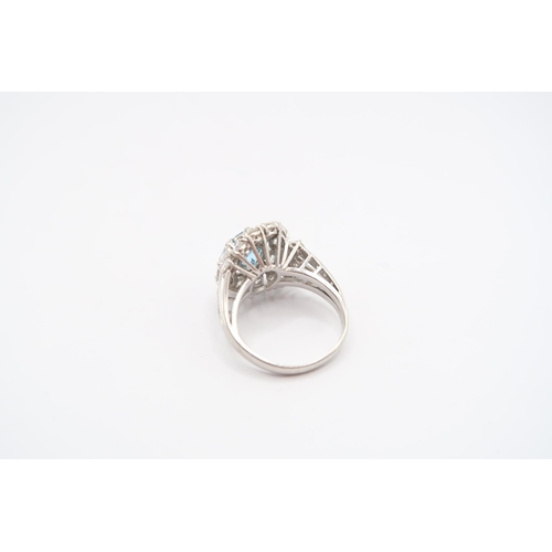 9 - An 18ct White Gold Aquamarine and Diamond Cluster Ring. Featuring a Raised Twist design with two mar... 