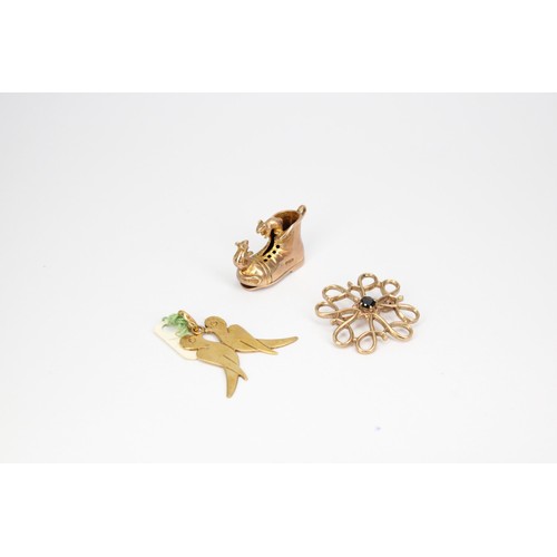 44 - Three pieces of 9ct jewellery to include a sapphire flower brooch, a mouse and boot charm and a bird... 