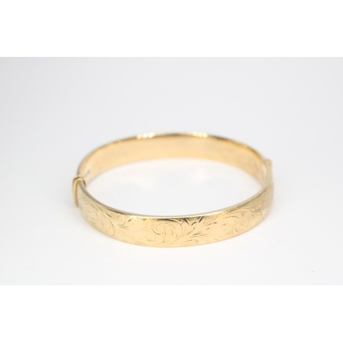 48 - A 9ct gold hinged bangle. Weight 18.04 grams