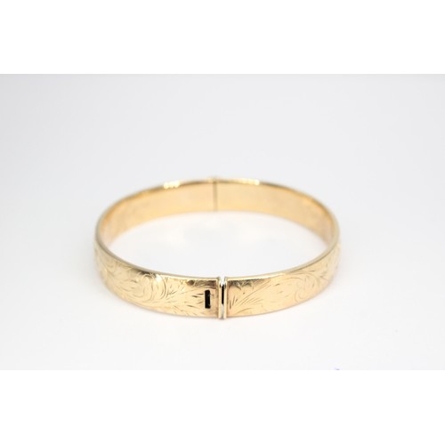 48 - A 9ct gold hinged bangle. Weight 18.04 grams